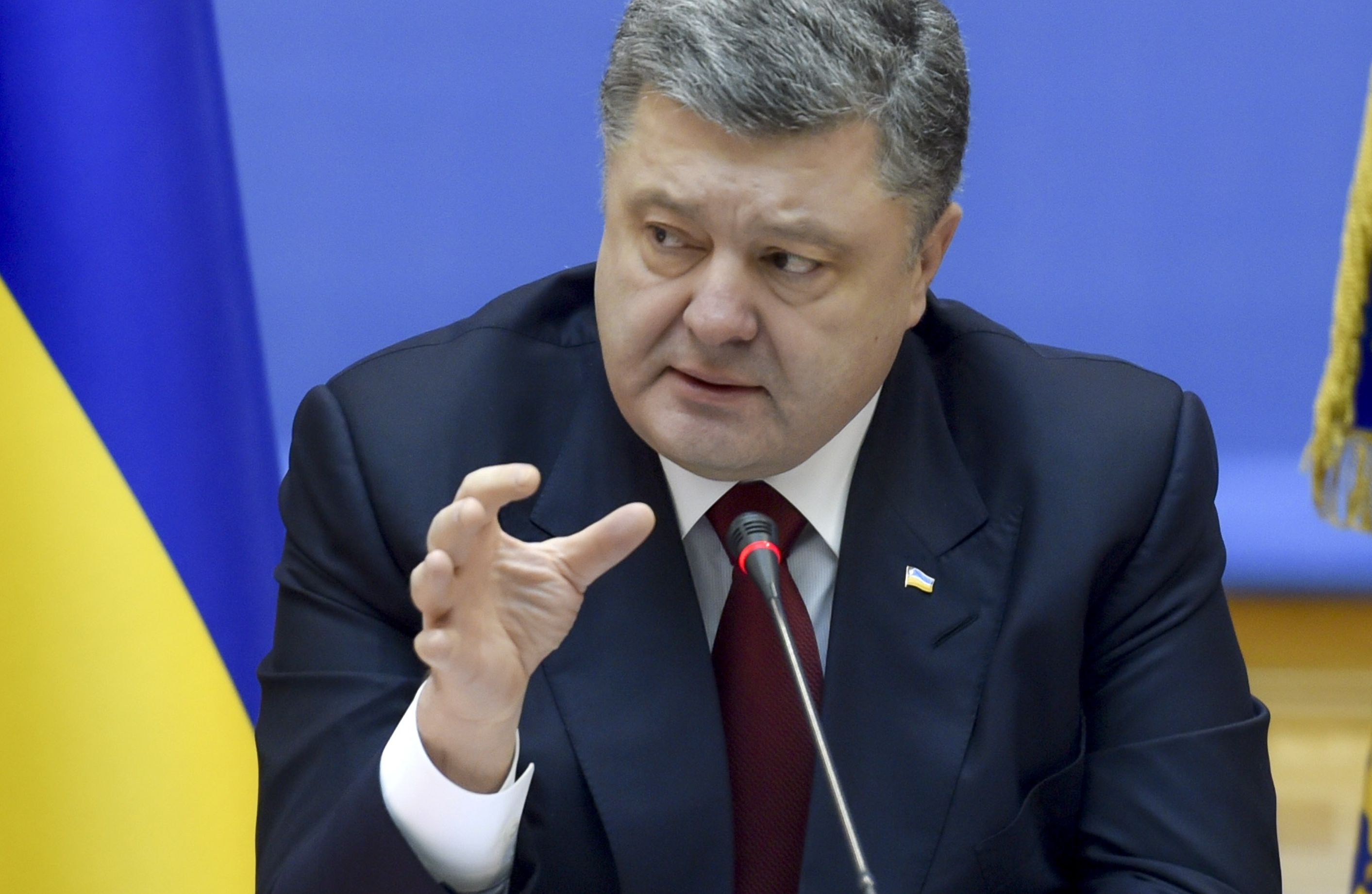 Ukrainian President Petro Poroshenko speaks during a government meeting in Kiev, February 11, 2015. Poroshenko said on Wednesday Ukraine was prepared to introduce martial law across Ukraine if the separatist conflict in the east escalates further, news agency Interfax reported. REUTERS/Mykola Lazarenko/Ukrainian Presidential Press Service/Handout via Reuters (UKRAINE - Tags: POLITICS CIVIL UNREST MILITARY CONFLICT) ATTENTION EDITORS - THIS PICTURE WAS PROVIDED BY A THIRD PARTY. REUTERS IS UNABLE TO INDEPENDENTLY VERIFY THE AUTHENTICITY, CONTENT, LOCATION OR DATE OF THIS IMAGE. FOR EDITORIAL USE ONLY. NOT FOR SALE FOR MARKETING OR ADVERTISING CAMPAIGNS. THIS PICTURE IS DISTRIBUTED EXACTLY AS RECEIVED BY REUTERS, AS A SERVICE TO CLIENTS